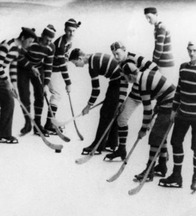 old photo of hockey players in striped outfits